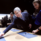 Apple CEO Tim Cook reaches for an Apple Watch in San Francisco.